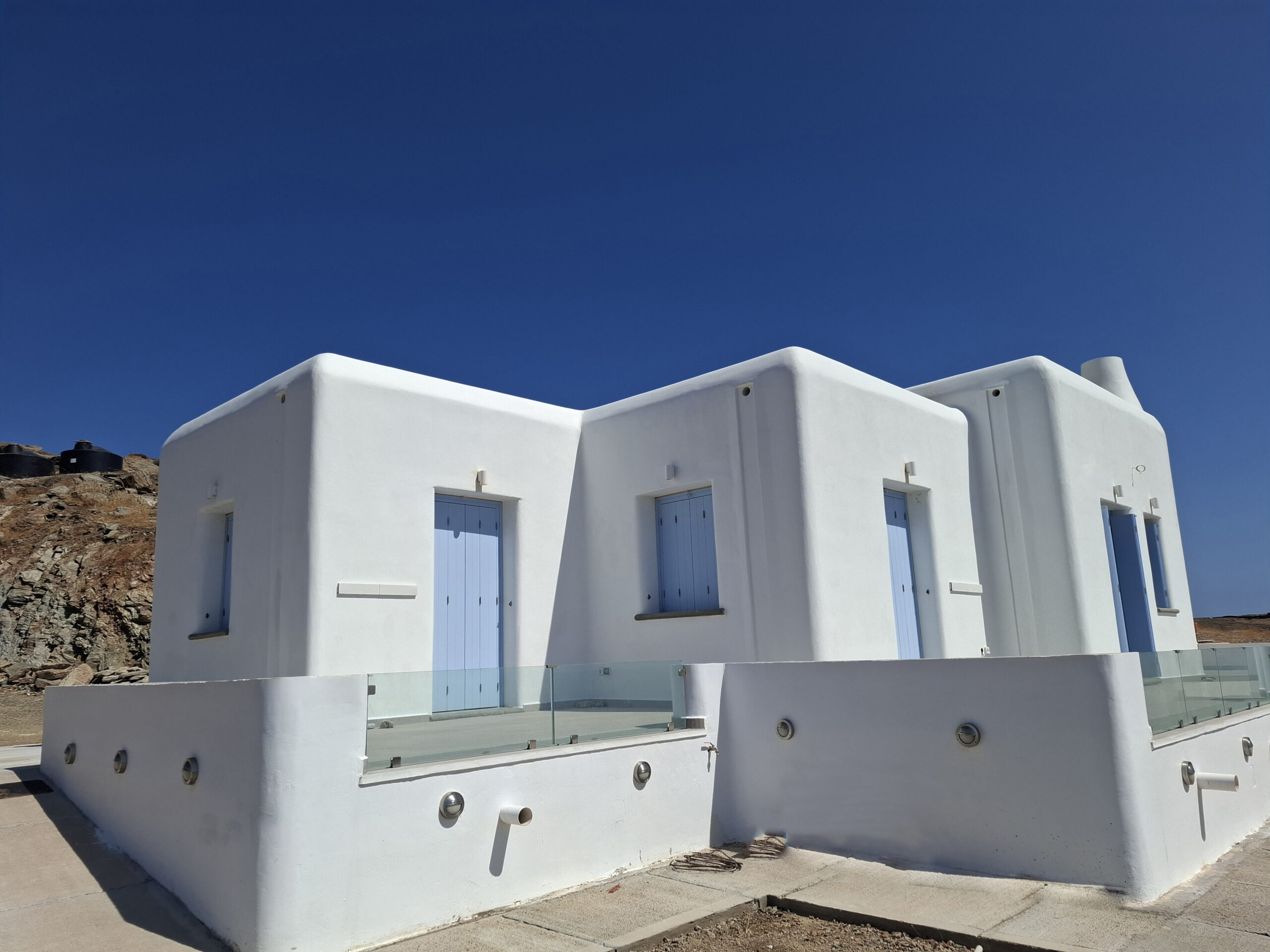 Sunlit interior with private balcony and sea view at Villa Manesi, Kythnos