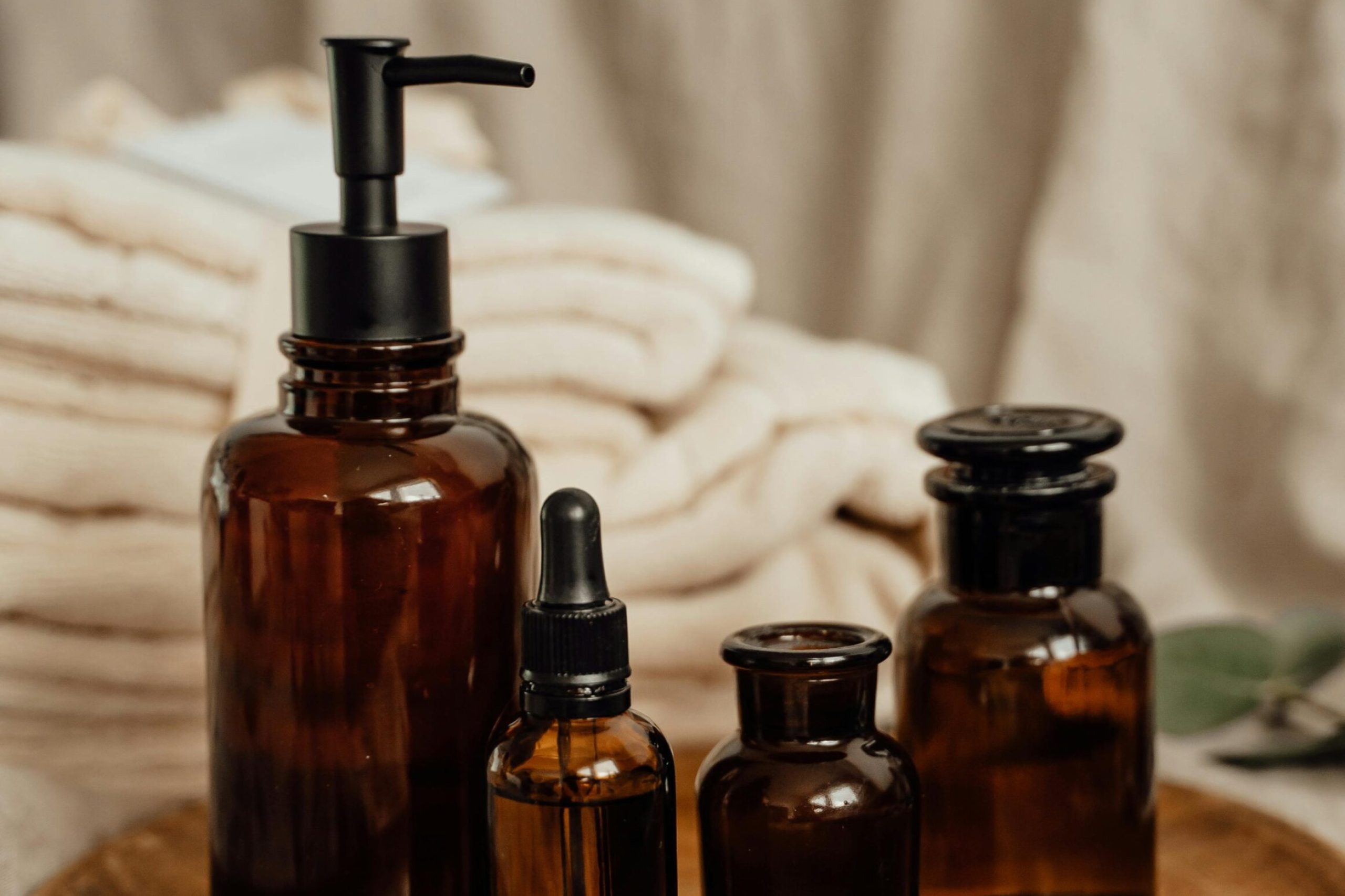 Luxury bathroom amenities arranged on a wooden tray
