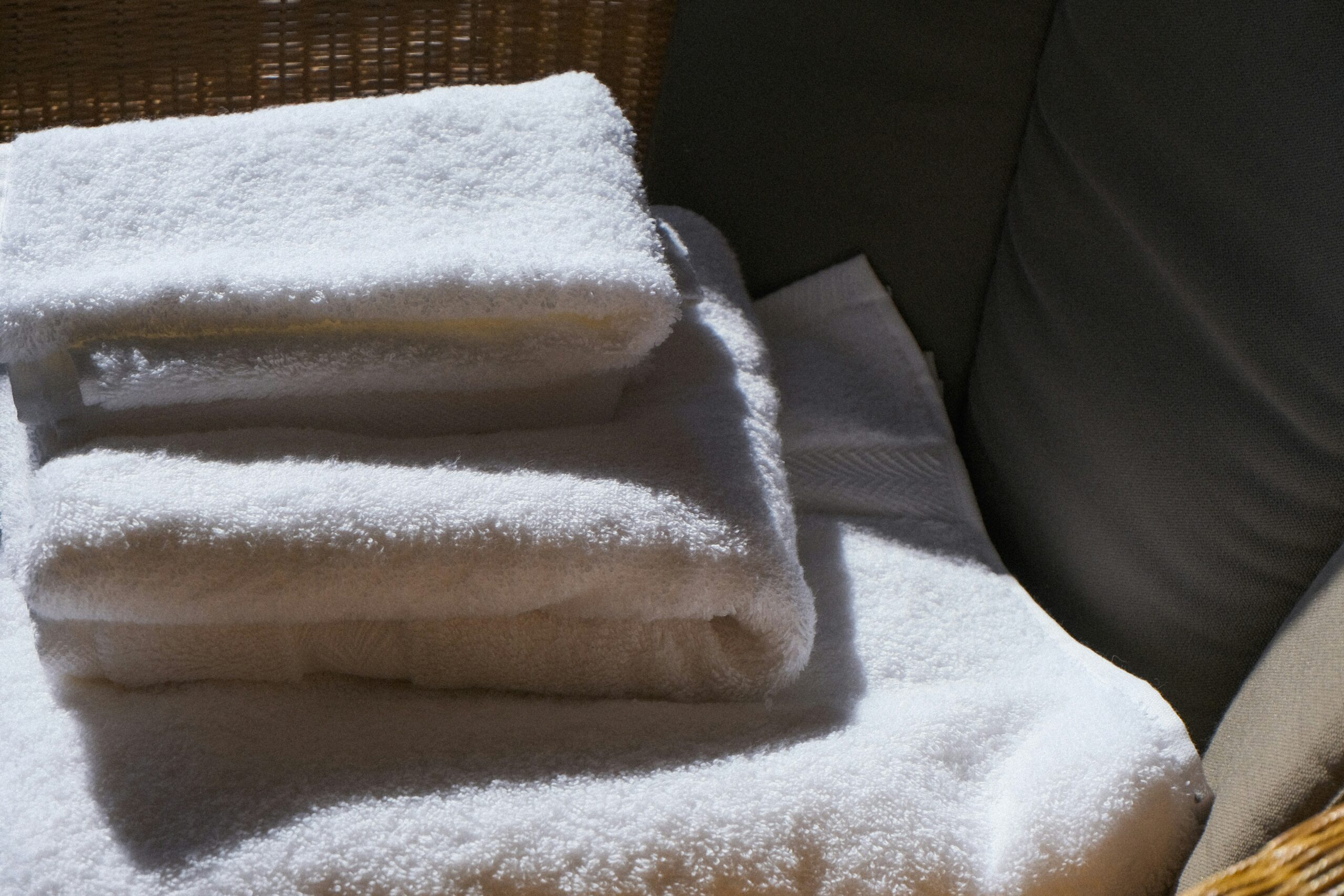 Freshly folded white towels for guest comfort